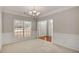 Dining room with wainscotting, neutral paint, and a large window allowing for plenty of natural light at 30 Barbara Ct, Fayetteville, GA 30215