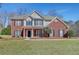 Charming two-story home with brick and siding exterior, complemented by a well-manicured lawn and landscaping at 30 Barbara Ct, Fayetteville, GA 30215