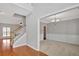 Bright foyer with hardwood floors, a staircase, and views into adjacent rooms creating an inviting entryway at 30 Barbara Ct, Fayetteville, GA 30215