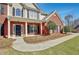 Inviting front entrance with brick columns, a black front door, and meticulously maintained landscaping at 30 Barbara Ct, Fayetteville, GA 30215