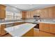 Well-lit kitchen with stainless steel appliances, a quartz countertop, and wooden cabinetry at 30 Barbara Ct, Fayetteville, GA 30215