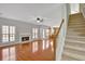 Large open living room with hardwood floors, a fireplace, and access to the kitchen at 30 Barbara Ct, Fayetteville, GA 30215