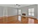 Bright living room featuring a fireplace, hardwood floors, and large windows at 30 Barbara Ct, Fayetteville, GA 30215