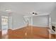 Open concept living room with fireplace, hardwood floors, and staircase at 30 Barbara Ct, Fayetteville, GA 30215