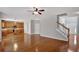 Spacious living room with hardwood floors, ceiling fan, and entrance to the kitchen area at 30 Barbara Ct, Fayetteville, GA 30215
