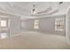Expansive main bedroom with tray ceiling, natural light, and neutral carpet at 30 Barbara Ct, Fayetteville, GA 30215