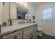 Bathroom with a gray vanity, marble countertop, and framed mirror at 3095 Wills Se St, Smyrna, GA 30080