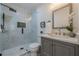 A modern bathroom with a glass-enclosed shower and gray vanity at 3095 Wills Se St, Smyrna, GA 30080