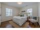 Bright bedroom with a double bed, a jute rug, and a decorative chair at 3095 Wills Se St, Smyrna, GA 30080