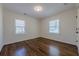 A well-lit empty bedroom with hardwood floors and white trim at 3095 Wills Se St, Smyrna, GA 30080