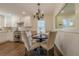 Charming dining area featuring a modern chandelier, cozy seating, and pass-through window to the kitchen at 3095 Wills Se St, Smyrna, GA 30080