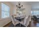 Charming dining area with a chandelier and a pass-through to the bright living room, perfect for entertaining at 3095 Wills Se St, Smyrna, GA 30080