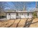 The rear exterior of a house, with white siding and black trim, featuring a spacious yard at 3095 Wills Se St, Smyrna, GA 30080