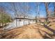 Home exterior, white siding, black trim, gravel walkway, and a large yard at 3095 Wills Se St, Smyrna, GA 30080