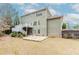 View of the home from the backyard. Features a deck and stone patio at 3621 Sutters Pond Way, Kennesaw, GA 30152