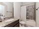 Modern bathroom features a granite countertop, tiled shower, and sleek fixtures at 3621 Sutters Pond Way, Kennesaw, GA 30152