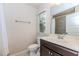Bathroom showcasing a single sink vanity, toilet, window, tiled floor, and a shower with a curtain at 3621 Sutters Pond Way, Kennesaw, GA 30152