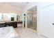 Bright bathroom featuring a soaking tub, granite counters, tile floors and a glass shower enclosure at 3621 Sutters Pond Way, Kennesaw, GA 30152