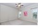 Bright bedroom with carpet, windows, neutral walls, and a ceiling fan at 3621 Sutters Pond Way, Kennesaw, GA 30152