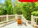 Wood deck with white railings and a large red umbrella, offering stunning views of the surrounding lush greenery at 3621 Sutters Pond Way, Kennesaw, GA 30152