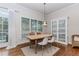 Cozy dining area with natural light, stylish furniture, and a decorative china cabinet at 3621 Sutters Pond Way, Kennesaw, GA 30152