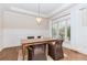 This dining room features hardwood floors, a modern chandelier, a tray ceiling, and wainscoting at 3621 Sutters Pond Way, Kennesaw, GA 30152