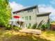 Back exterior of home featuring stone patio, deck, landscaped yard, and lush trees provides a private outdoor oasis at 3621 Sutters Pond Way, Kennesaw, GA 30152