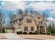 Lovely two-story brick home showcasing attached garage, complemented by well-maintained landscaping at 3621 Sutters Pond Way, Kennesaw, GA 30152