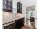 Elegant kitchen area features granite countertops, a wine cooler, and dark wood cabinetry at 3621 Sutters Pond Way, Kennesaw, GA 30152