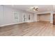 Open concept living room featuring beautiful floors, bench seating, and ceiling fan at 3621 Sutters Pond Way, Kennesaw, GA 30152