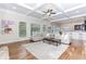 Open-concept living room with coffered ceiling flowing into a dining area and kitchen at 3621 Sutters Pond Way, Kennesaw, GA 30152