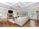 Spacious living room with fireplace, built-in cabinets, coffered ceiling and natural light at 3621 Sutters Pond Way, Kennesaw, GA 30152