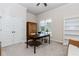 Well-lit home office featuring a large window, neutral walls, and built-in shelving at 3621 Sutters Pond Way, Kennesaw, GA 30152