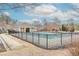 Community pool featuring a surrounding black fence, clubhouse, and nearby residential buildings at 3621 Sutters Pond Way, Kennesaw, GA 30152