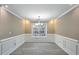 Formal dining room with wainscoting detail, providing an elegant space for entertaining at 414 Shadetree Ln, Lawrenceville, GA 30044