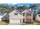 Charming two-story home featuring brick and siding, a manicured lawn, and an attached two-car garage at 414 Shadetree Ln, Lawrenceville, GA 30044