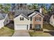 Charming two-story home featuring brick and siding, a manicured lawn, and an attached two-car garage at 414 Shadetree Ln, Lawrenceville, GA 30044