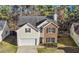 Charming two-story home featuring brick and siding, a manicured lawn, and an attached two-car garage at 414 Shadetree Ln, Lawrenceville, GA 30044