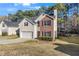 Charming two-story home featuring brick and siding, a manicured lawn, and an attached two-car garage at 414 Shadetree Ln, Lawrenceville, GA 30044