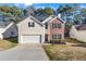 Charming two-story home featuring brick and siding, a manicured lawn, and an attached two-car garage at 414 Shadetree Ln, Lawrenceville, GA 30044