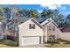 Charming two-story home featuring brick and siding, a manicured lawn, and an attached two-car garage at 414 Shadetree Ln, Lawrenceville, GA 30044