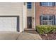 View of the front entrance of a charming two-story home featuring brick and siding and an attached two-car garage at 414 Shadetree Ln, Lawrenceville, GA 30044