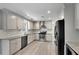 Well-lit kitchen with stainless steel appliances, ample counter space, and sleek white cabinetry at 414 Shadetree Ln, Lawrenceville, GA 30044