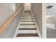 Elegant staircase features wooden handrail, white risers, and stained treads at 414 Shadetree Ln, Lawrenceville, GA 30044