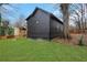 Black home with a well-manicured backyard and a side stairwell at 875 Center Hill Nw Ave, Atlanta, GA 30318