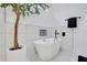 A modern bath features a standalone tub with matte black fixtures and a modern tree at 875 Center Hill Nw Ave, Atlanta, GA 30318