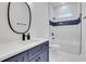 Modern bathroom with a stylish vanity, mirror, and a shower-tub combo with tile surround at 875 Center Hill Nw Ave, Atlanta, GA 30318