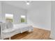 Bright bedroom featuring wood flooring, white walls, and two windows with natural light at 875 Center Hill Nw Ave, Atlanta, GA 30318