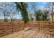 Wooden deck surrounded by a wooden railing, overlooks wooded area and trees at 875 Center Hill Nw Ave, Atlanta, GA 30318