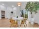 Bright dining room featuring hardwood floors, designer light fixture, and access to the outdoor living space at 875 Center Hill Nw Ave, Atlanta, GA 30318